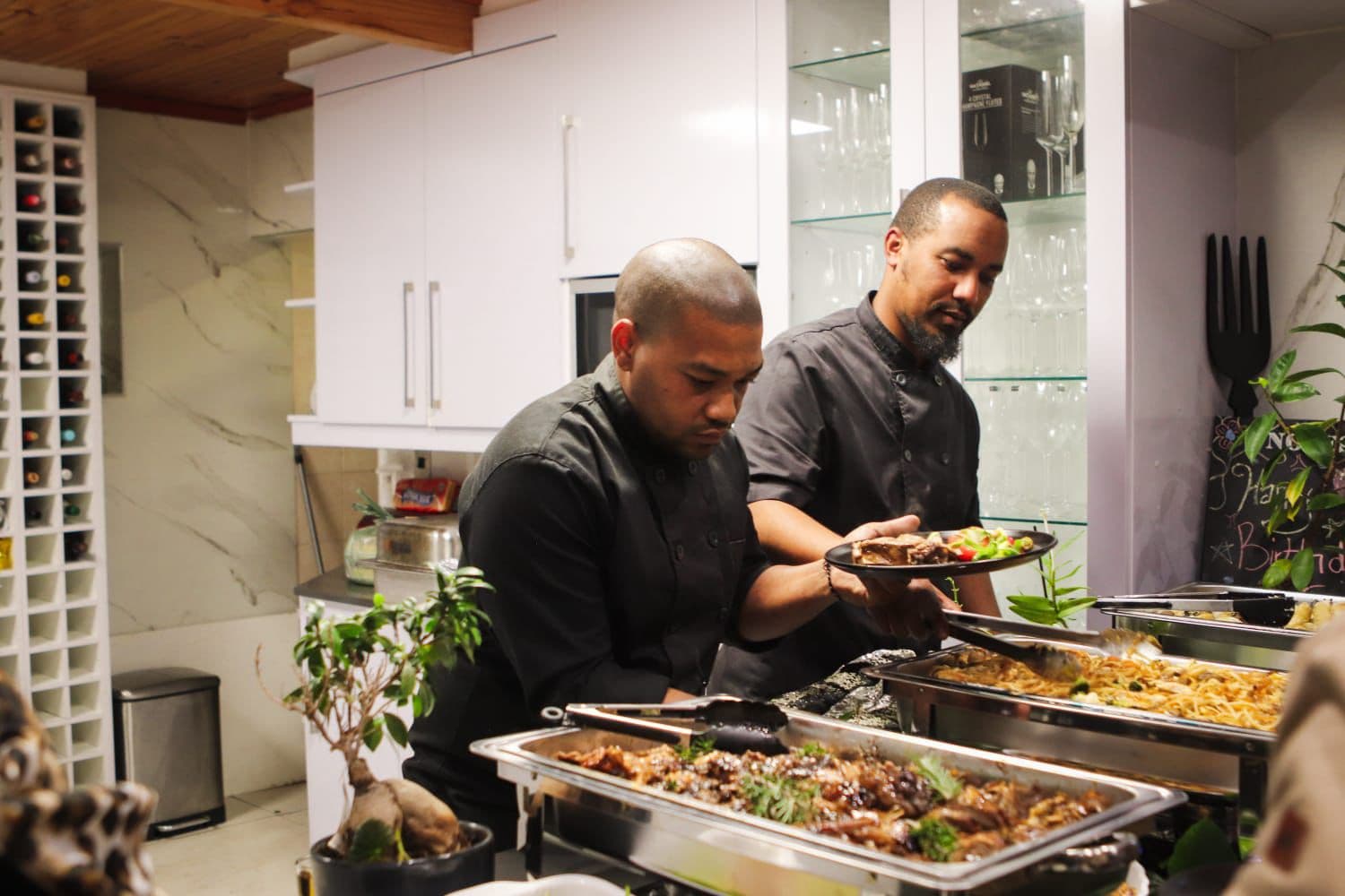 Chefs plating buffet dishes for guests
